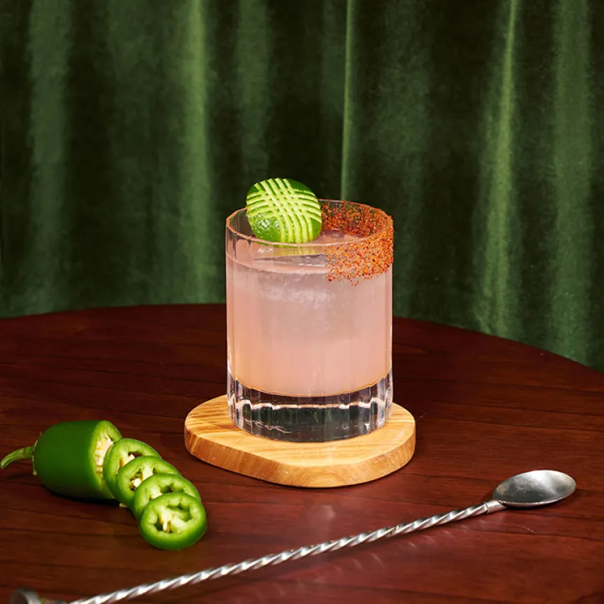 A spicy tequila twist on the classic cosmopolitan, Some Like it Hot, in a rocks glass