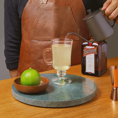 combining all ingredients of the hot margarita in a mug