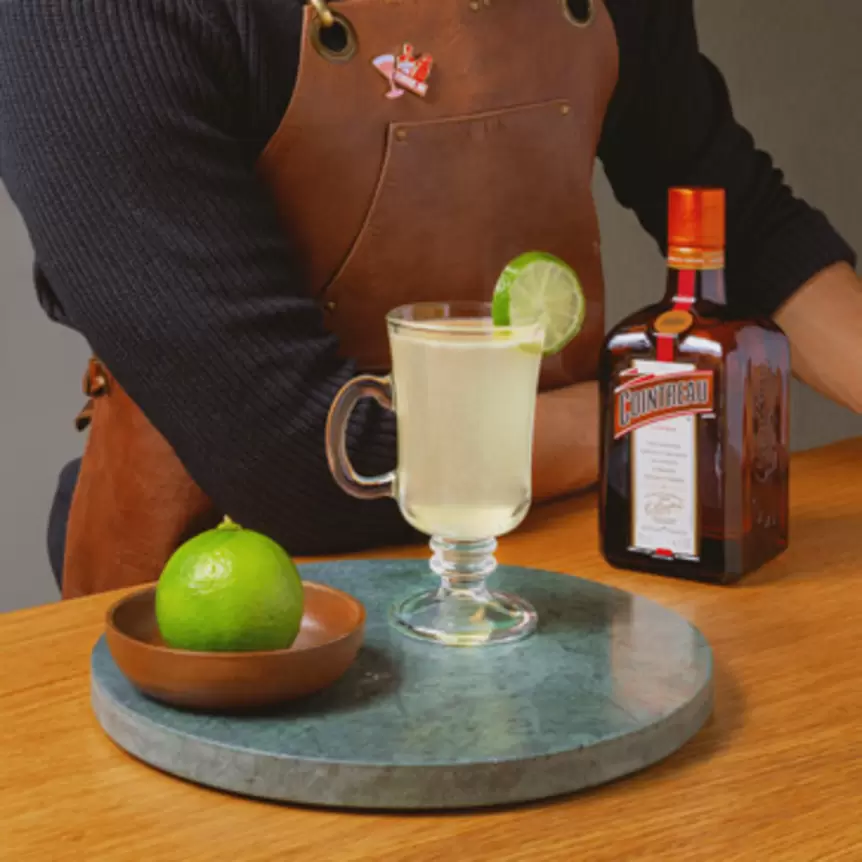 hot margarita with limes and cointreau bottle