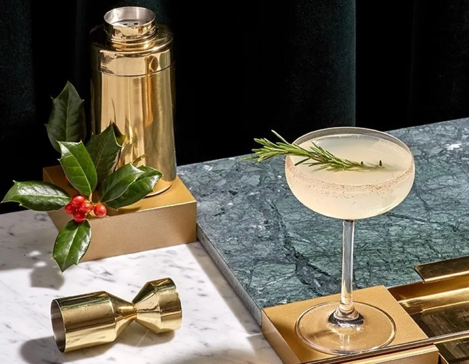 The Cointreau Holiday Margarita next to a gold shaker