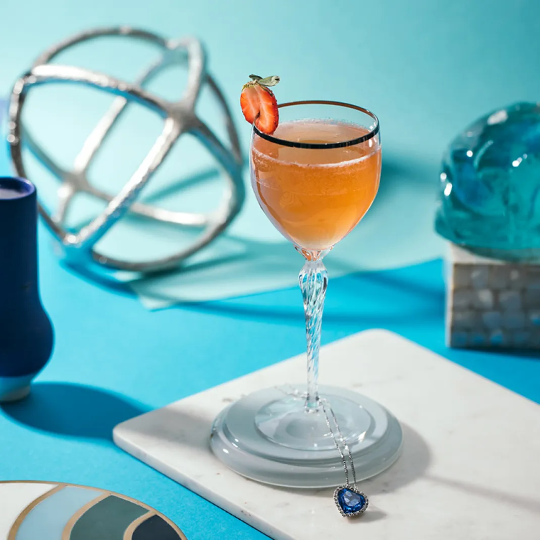 An ocean themed cocktail, Heart of the Ocean, in a chilled cocktail glass