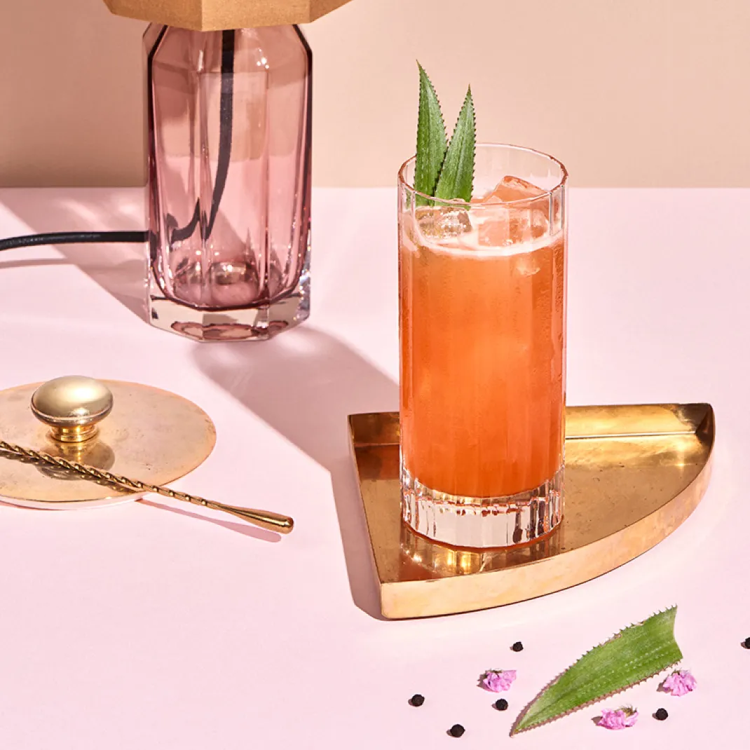 A Singapore Sling cocktail in a chilled highball glass