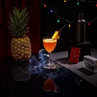 The Pineapple Upside Down drink served in a coupe glass